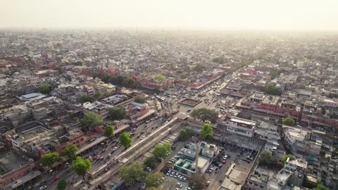 Rotating aerial drone movement shot of crossroads traffic passing in Indian city Stock Footage 249836610