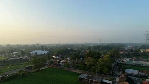 Rotating aerial drone view of green rice fields and rural village. Stock Footage 342086625