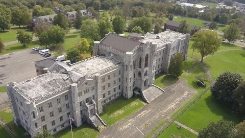 Rotating aerial of old abandoned asylum Stock Footage 80404912