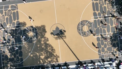 Rotating aerial Rucker Park leaf logo basketball court Harlem NYC Stock Footage 218634495