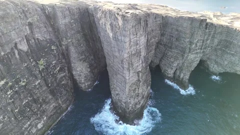 Rotating Aerial Shot of Towering Cliffs and Lake Sørvágsvatn – Faroe Islands Stock Footage 313496976