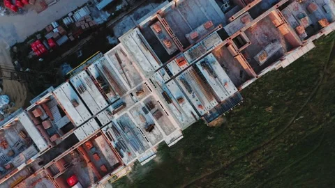 Rotating aerial top view of the construction of a residential building at sunset Stock Footage 158872672