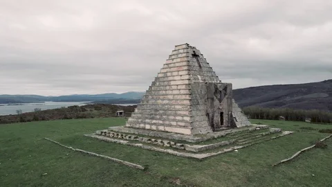 Rotating aerial view of an abandoned pyramid shape ruin Stock Footage