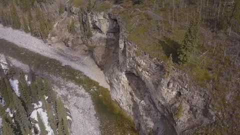 Rotating aerial view of a boreal river canyon in spring Stock Footage 107985975