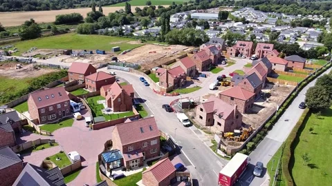 Rotating aerial view of a large housing estate currently under construction Stock Footage 339614345