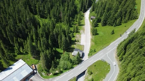 Rotating Aerial View of a Winding Mountain Road Through Dense Green Forest .. Stock Footage 318971694