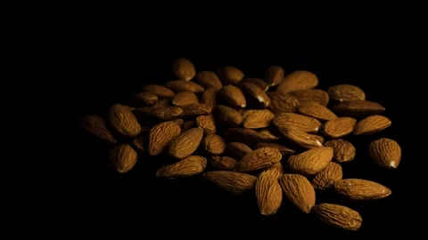Rotating Almonds on Dark Background Close Up Stock Footage 329966411