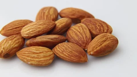 Rotating of almonds on white background. Side view. Stock Footage 136050285