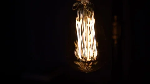 Rotating Around Illuminated Edison Light Bulb Handheld Stock Footage 102348881