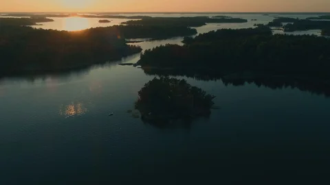 Rotating around small island in the archipelago during golden hour Video stock 114003783