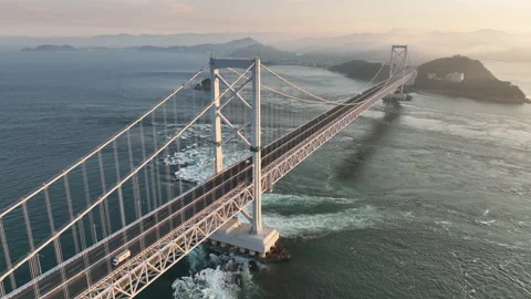 Rotating around suspension bridge with light traffic over strong current Stock Footage 201946250