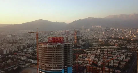 Rotating Around Tower in Construction Building Drone Aerial Shot in Tehran Vídeo Stock 144786091