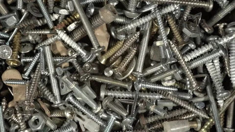 A rotating assortment of hardware, screws, nuts, bolts, and nails Stock Footage 194540011