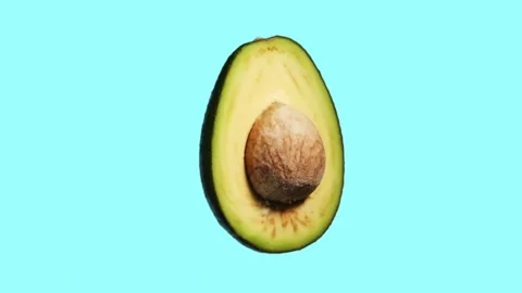 Rotating avocado pattern on cyan background Stock Footage 156813246