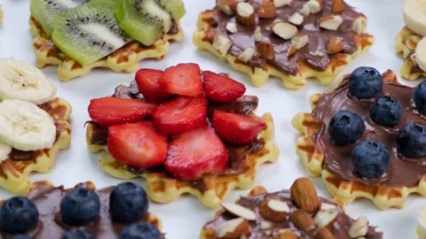 Rotating background of appetizing sweet wafers with chocolate spread, nuts and Stock Footage 195625416