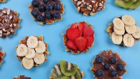 Rotating background of appetizing sweet wafers with chocolate spread, nuts and Stock Footage 196125011