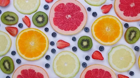 Rotating background of blueberries, strawberries, lemon, orange, grapefruit and Stock Footage 204016670