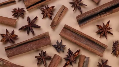 Rotating background with cinnamon sticks and anise stars on a beige background Stock Footage 212033995