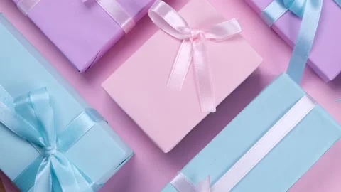 Rotating background with colorful gift boxes with ribbons and bows in pastel Stock Footage 211333305