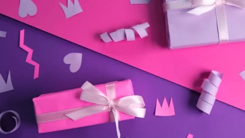 Rotating background with colorful pink gift boxes with ribbons and bows in Stock Footage 247959375