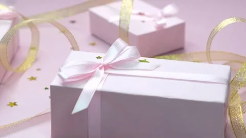 Rotating background with colorful pink gift boxes with ribbons and bows in Stock Footage 249112513