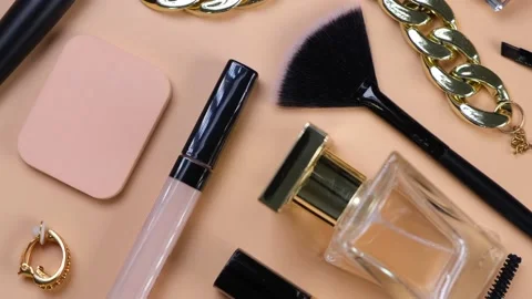 Rotating background with decorative cosmetics and bijouterie, chain bracelet and Stock Footage 211421115