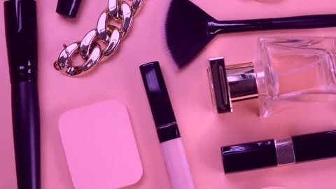 Rotating background with decorative cosmetics and bijouterie, chain bracelet and Stock Footage 218306497