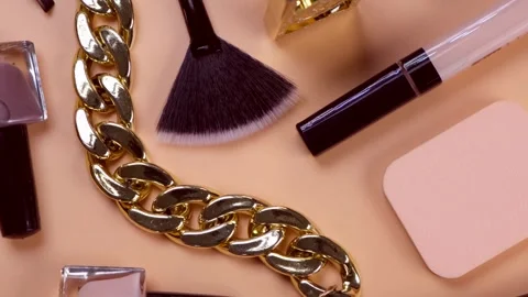 Rotating background with decorative cosmetics and bijouterie, chain bracelet and Stock Footage 246008501
