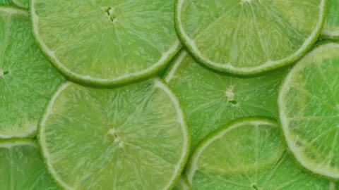 Rotating background of lime slices close-up, fresh summer bright background Stock Footage 196149204