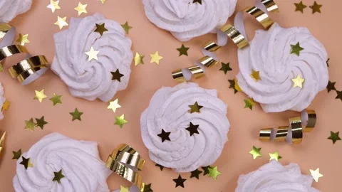 A rotating background of marshmallows or birthday cakes on a beige or peach Stock Footage 197077830