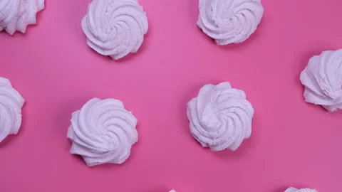 Rotating background of marshmallows or cakes, birthday cakes on a pink Stock Footage 197332372