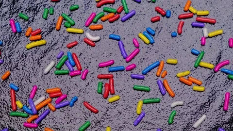 Rotating background of multi-colored sprinkles for sweets and multi-colored Stock Footage 198023009