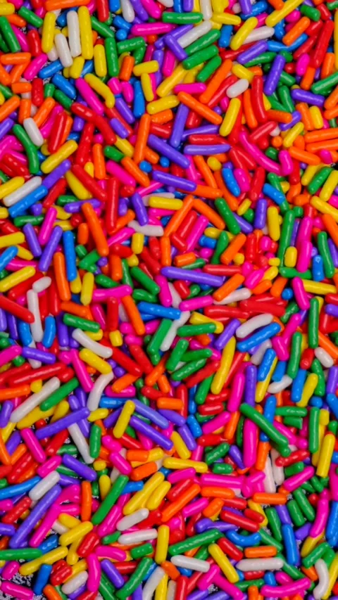 Rotating background of multi-colored sprinkles for sweets . The concept of Stock Footage 278882560