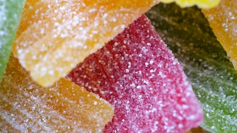 Rotating background from multi-colored sweet marmalade in sugar Stock Footage 232728191