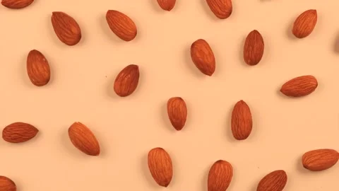 Rotating background nuts almonds on a beige background, the concept of healthy Stock Footage 196148047