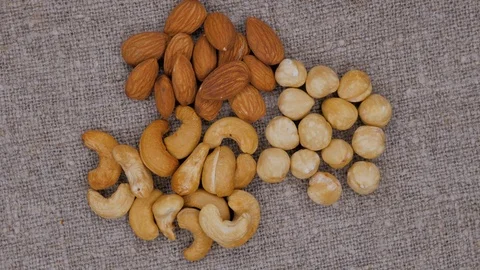 Rotating background of nuts mix. Cashew. Hazelnut. Almond. Assorted nuts. Stock Footage 105145575
