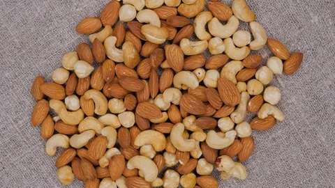Rotating background of nuts mix. Cashew. Hazelnut. Almond. Assorted nuts. Stock Footage 105281550