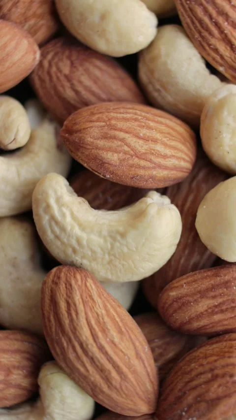 Rotating background of nuts mix. Cashew. Almond. Assorted nuts. Vertical video. Stock Footage 271642318