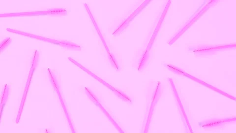 Rotating background with pink brushes for eyelashes or eyebrows on a pink Stock Footage 211127645