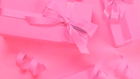 Rotating background with pink gift boxes with pink bows on a pink background top Stock Footage 211806050