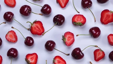 Rotating background of ripe strawberries and cherries on a white background Stock Footage 198025940