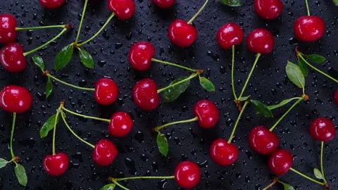 Rotating background of ripe wet cherries with water drops on a black background Stock Footage 200003816