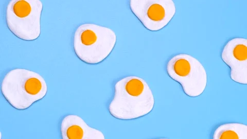 Rotating background of scrambled eggs on a blue background, close-up top view Stock Footage 198396904