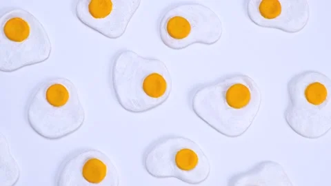 Rotating background of scrambled eggs on a white background, close-up top view Stock Footage 200003768