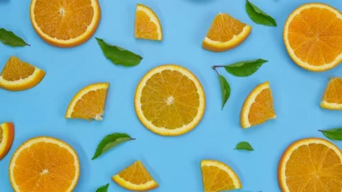 Rotating background with slides of orange and leaves on a blue background Stock Footage 197001255