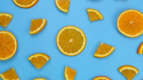 Rotating background with slides of orange on a blue background, trendy summer Stock Footage 210172846