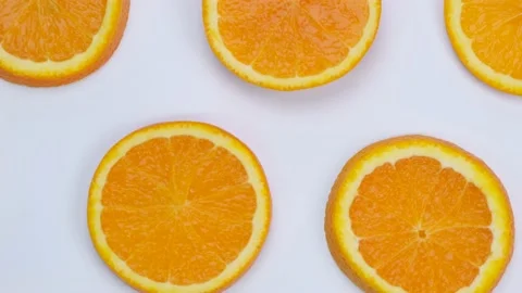 Rotating background with slides of orange on a white background, trendy summer Stock Footage 197077908
