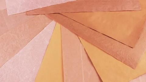 Rotating background of various brown, beige, and tan handmade papers.  Video stock 330242244
