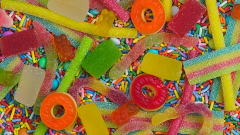 Rotating background of various jelly sweets, bears, donuts, candies, sprinkles Stock Footage 245627392
