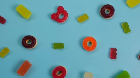 Rotating background of various jelly sweets, bears, donuts, candies, sprinkles Stock Footage 246173329